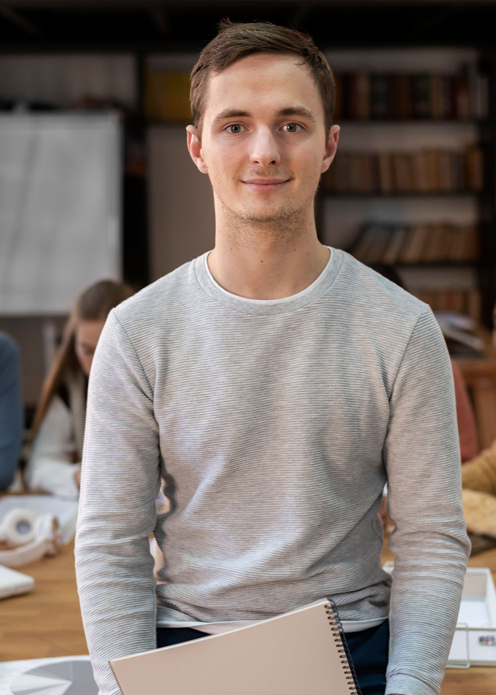 Student posing during a group study session with colleagues