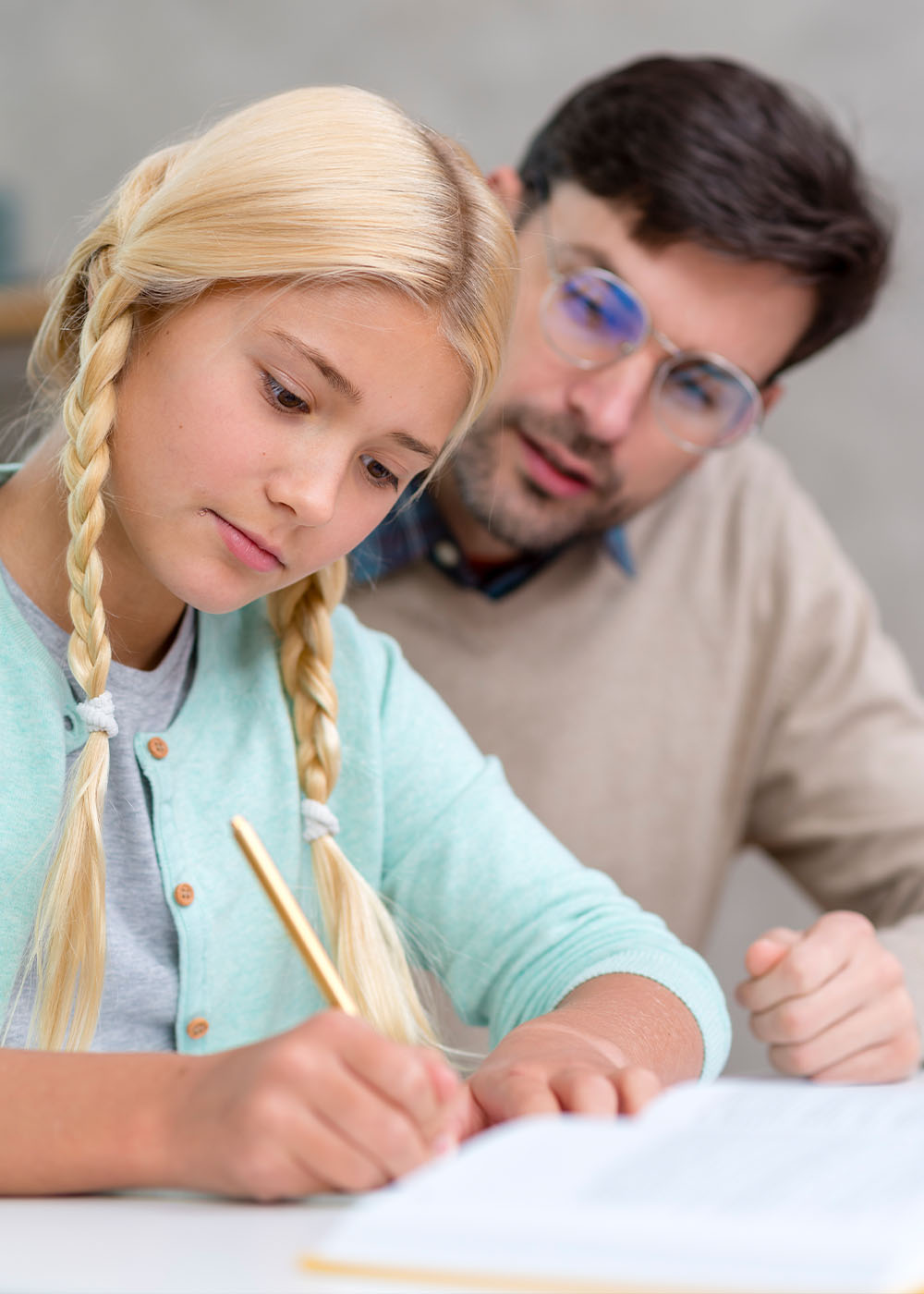 Teacher and young student being focused