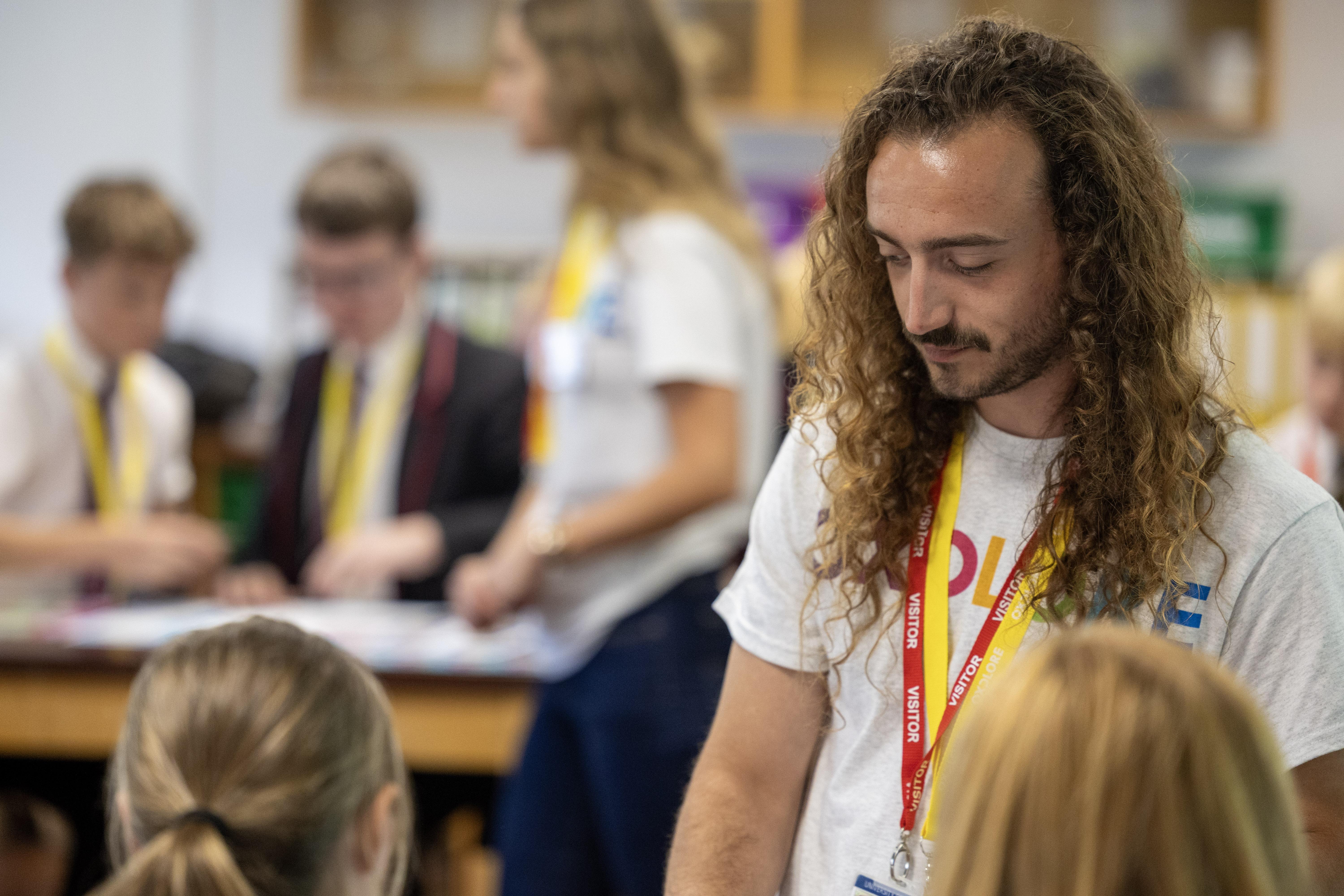 An Oxplore facilitator talks to young people in a classroom